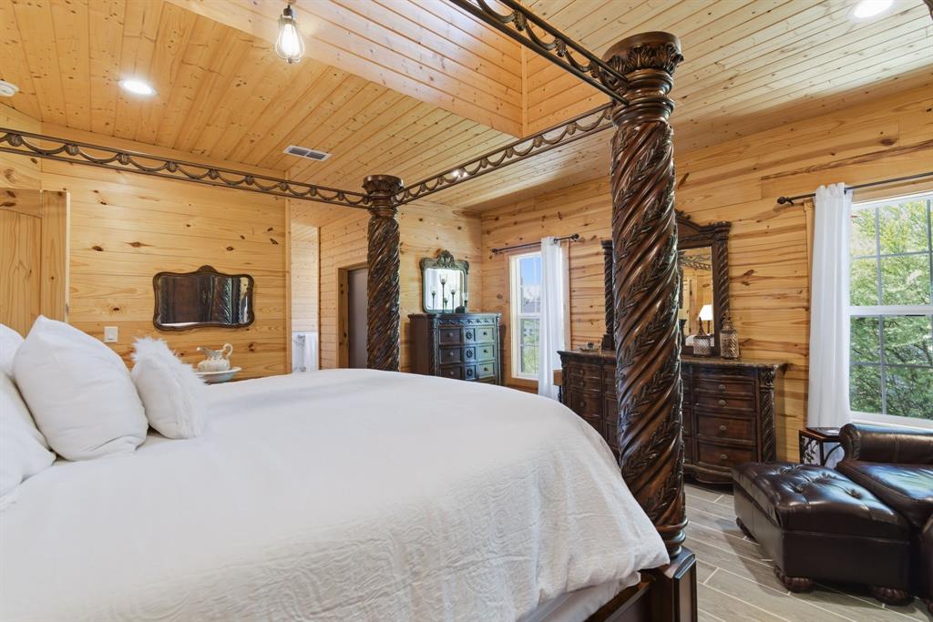 118 Heath Street Hico, TX 76457 - Photo 23 of 39 a bedroom with a bed a flat screen tv and balcony