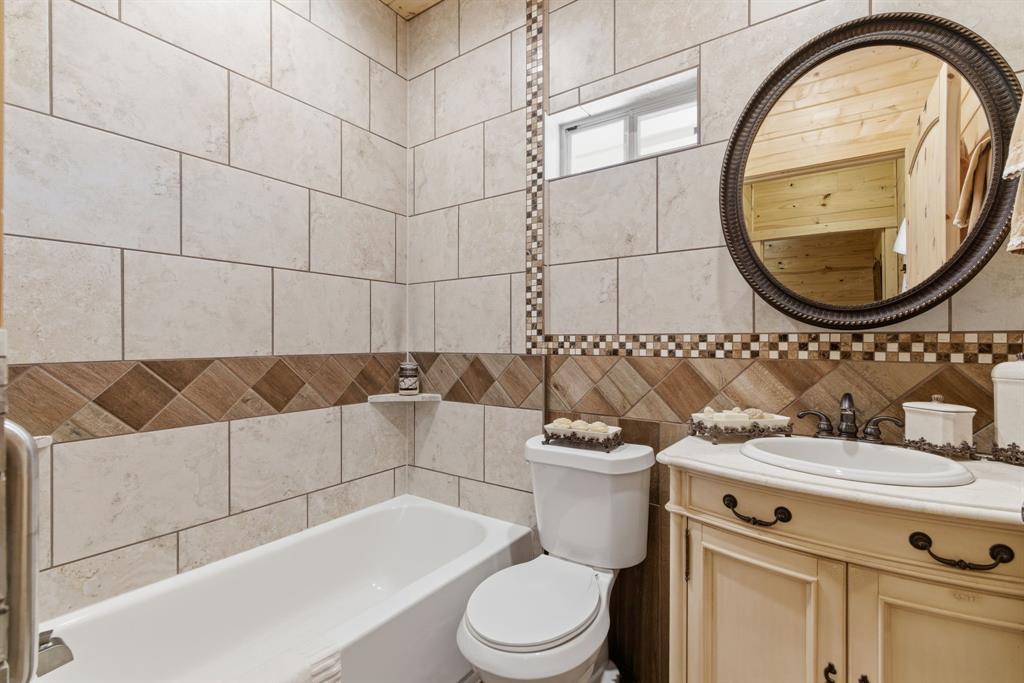 118 Heath Street Hico, TX 76457 - Photo 32 of 39 a bathroom with a sink a toilet and a mirror