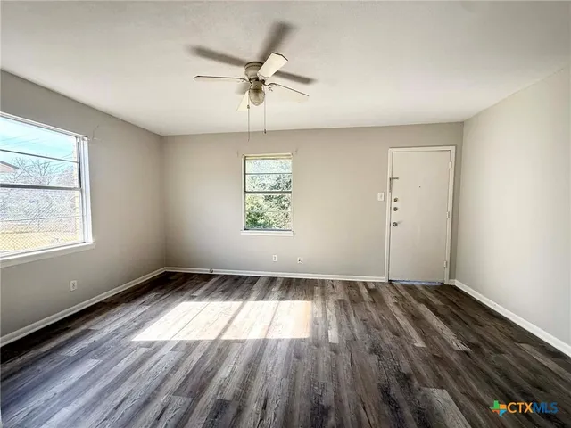 wooden floor in an empty room with a window