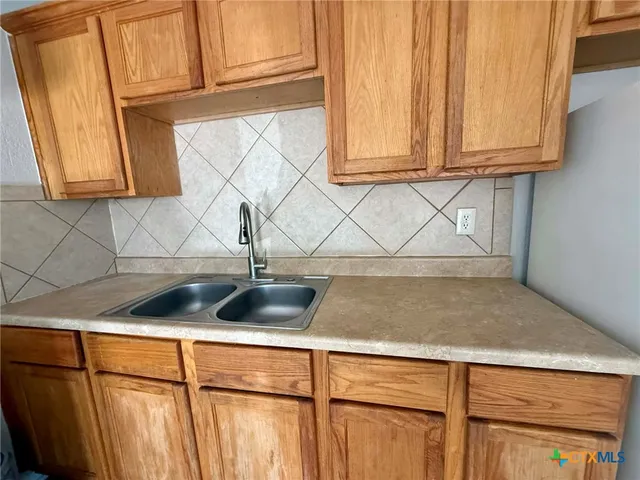 a kitchen with a sink and cabinets