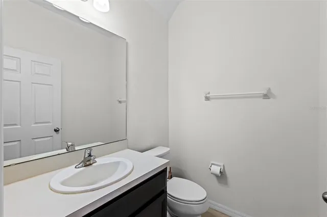 a bathroom with a sink toilet and vanity
