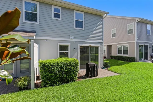 a view of a house with a yard and sitting area