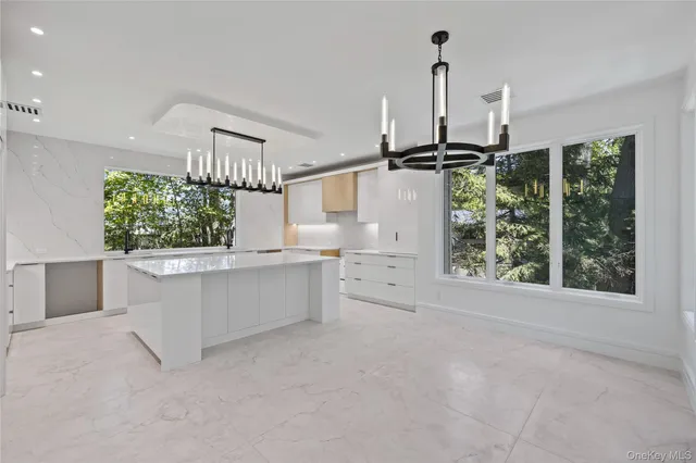 a view of a kitchen with furniture and window in it