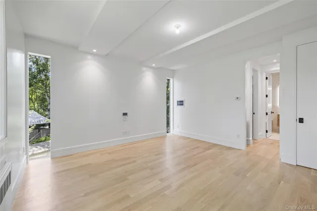 a view of a room with wooden floor and a bathroom