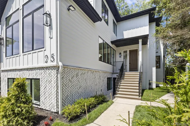 a front view of a house with a garden