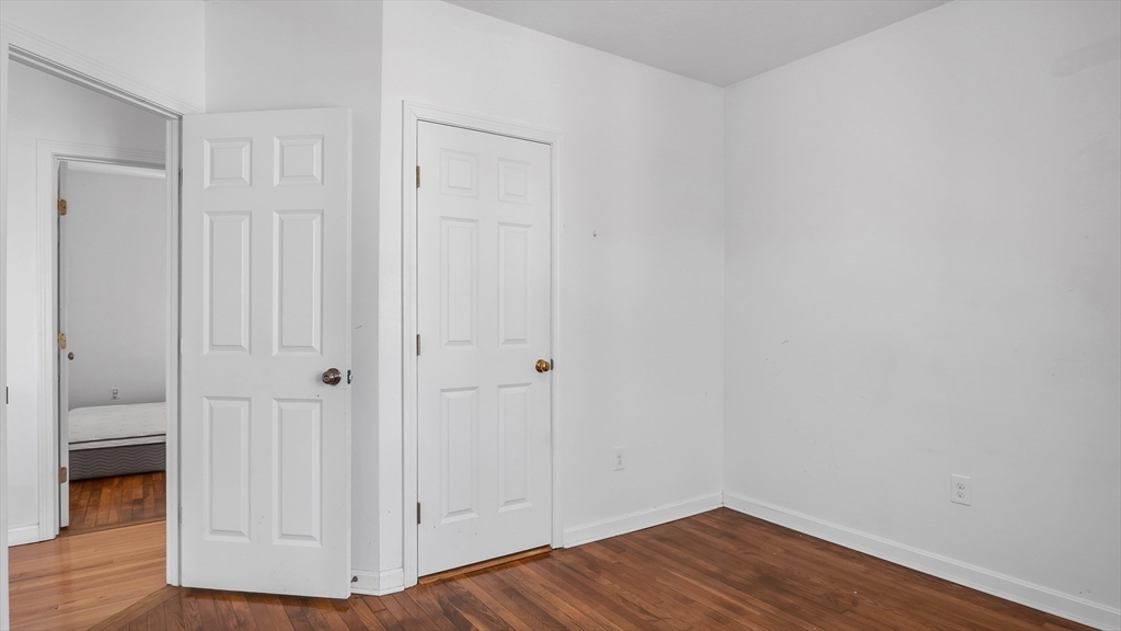 1442 Main Street, Unit 1 Worcester, MA 01603 - Photo 14 of 30 a view of an empty room with wooden floor