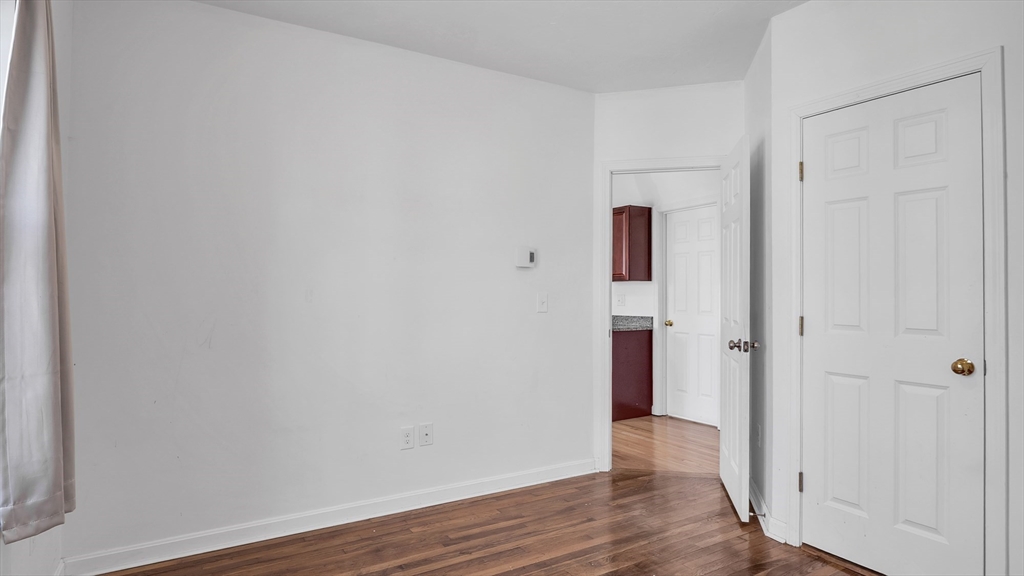 1442 Main Street, Unit 1 Worcester, MA 01603 - Photo 15 of 30 a view of an empty room with wooden floor