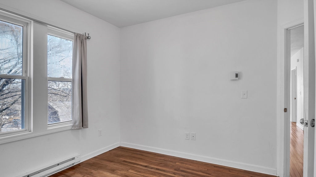 1442 Main Street, Unit 1 Worcester, MA 01603 - Photo 16 of 30 a view of a small space with wooden floor and a window