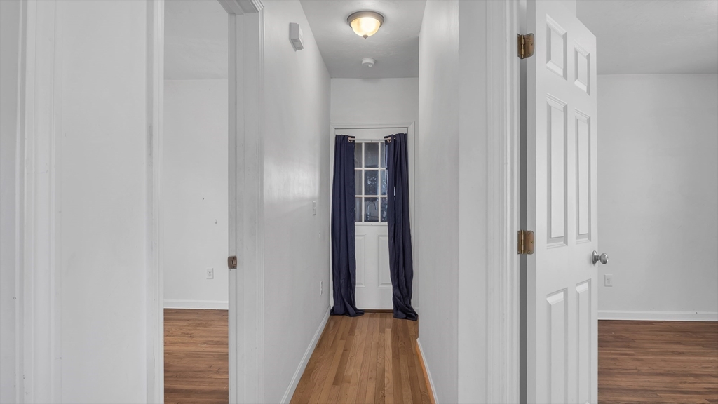 1442 Main Street, Unit 1 Worcester, MA 01603 - Photo 17 of 30 a view of a hallway with wooden floor and staircase