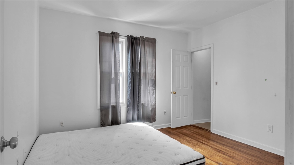 1442 Main Street, Unit 1 Worcester, MA 01603 - Photo 18 of 30 a view of an empty room with wooden floor