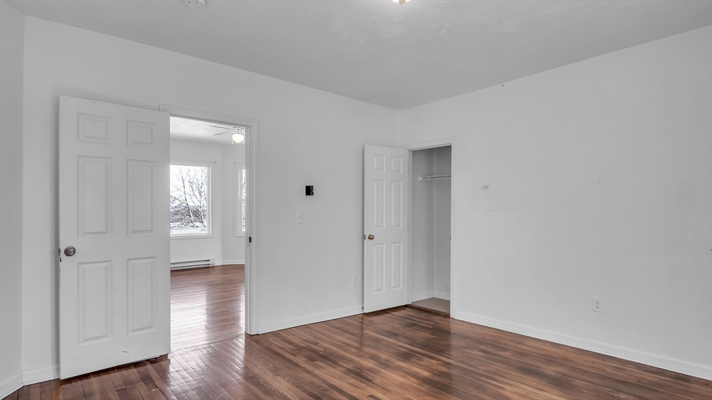 1442 Main Street, Unit 1 Worcester, MA 01603 - Photo 26 of 30 an empty room with wooden floor & windows
