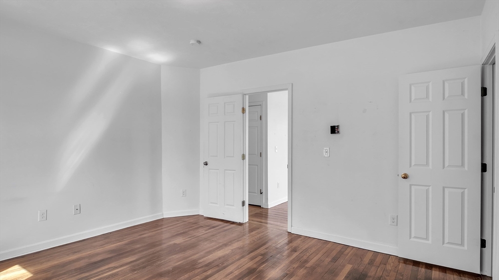 1442 Main Street, Unit 1 Worcester, MA 01603 - Photo 27 of 30 a view of an empty room with wooden floor