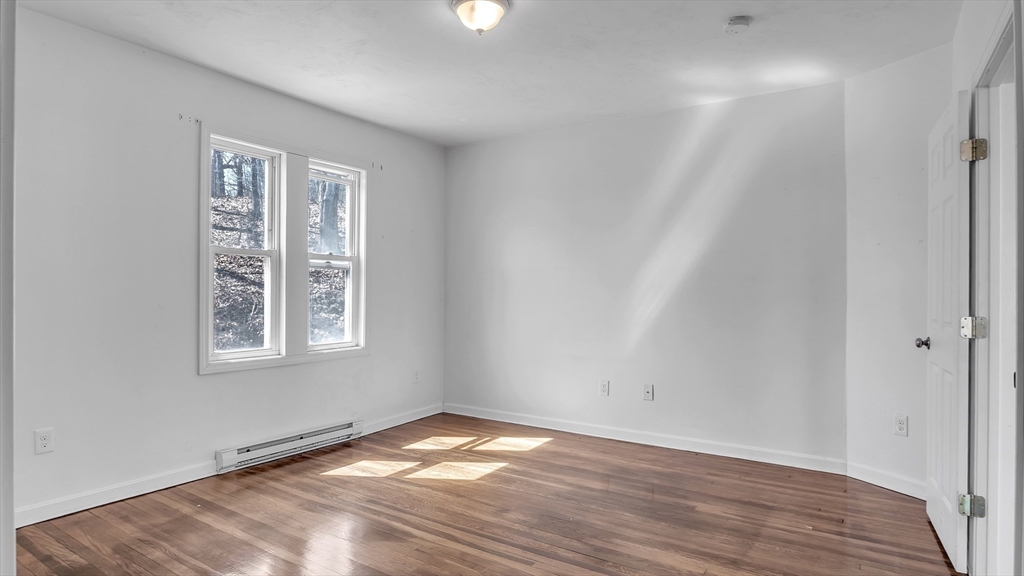 1442 Main Street, Unit 1 Worcester, MA 01603 - Photo 28 of 30 a view of empty room with wooden floor and fan