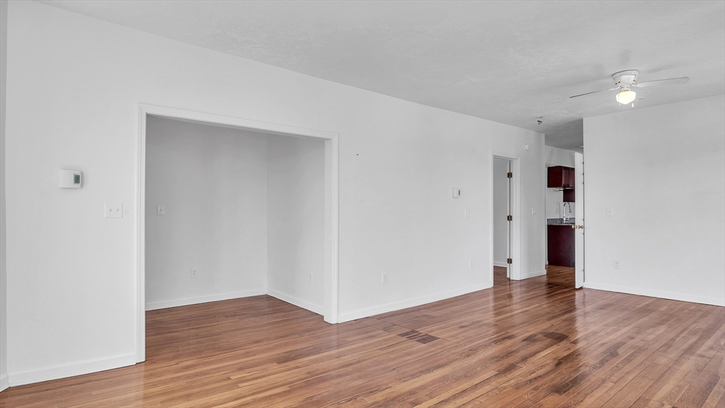 1442 Main Street, Unit 1 Worcester, MA 01603 - Photo 5 of 30 a view of an empty room with wooden floor