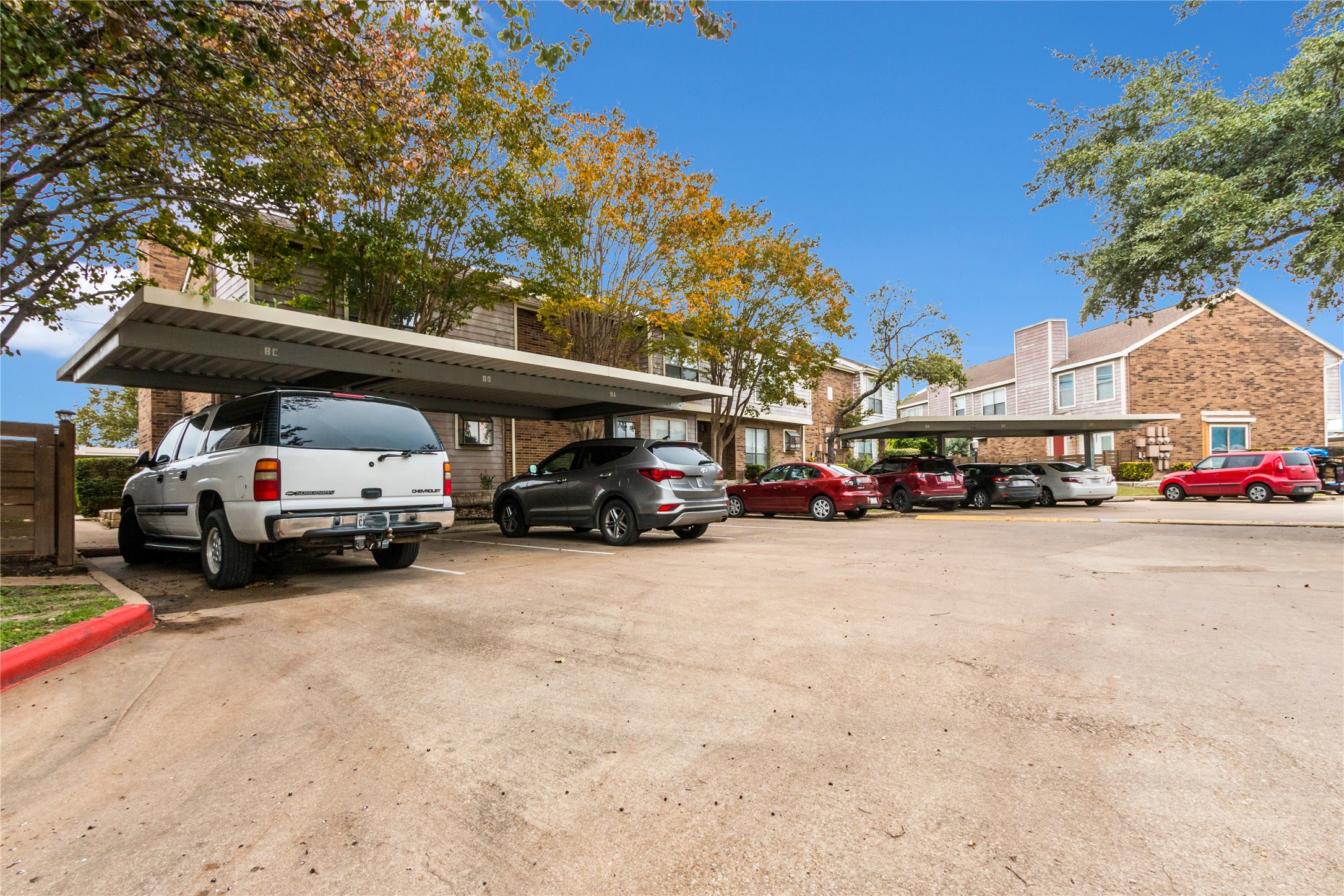 2018 West Rundberg Lane, Unit 9A Austin, TX 78758 - Photo 30 of 30 View of carport. Reserved space is 3rd to right (where grey mid size SUV sits).