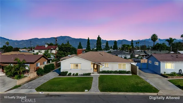 a front view of a house with a yard and street