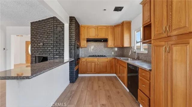 a kitchen with a sink a counter top space and cabinets