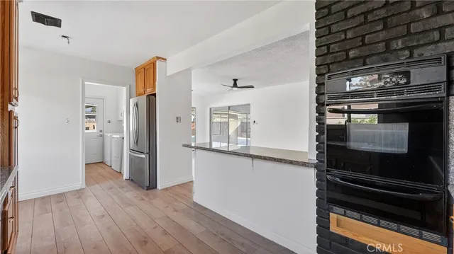 a kitchen with a refrigerator and microwave