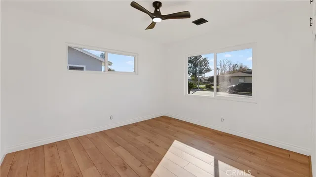 a room with a window and a ceiling fan