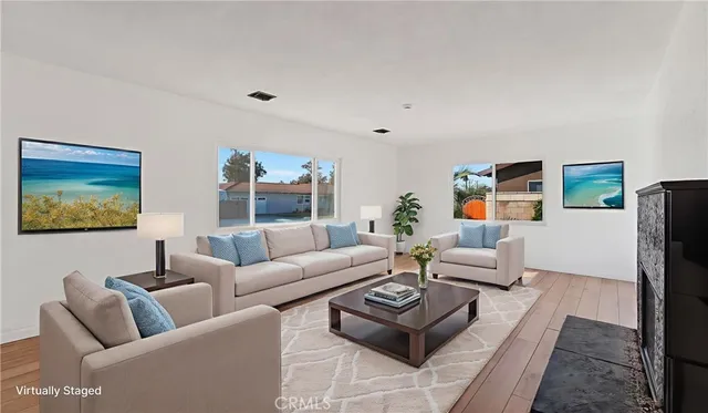 a living room with furniture a rug and a large window