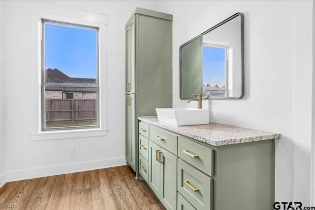 a bathroom with a sink a toilet and mirror