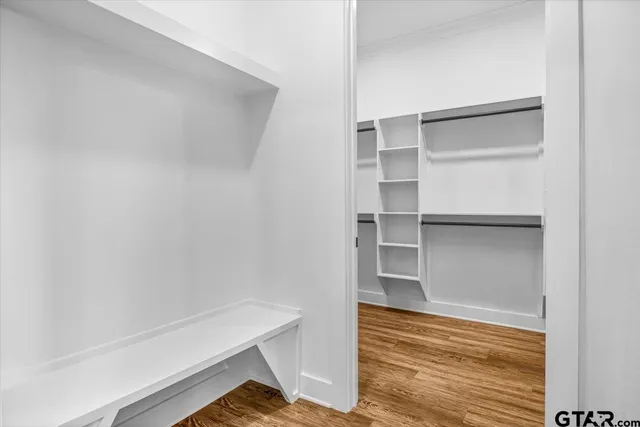 a view of walk in closet with empty racks