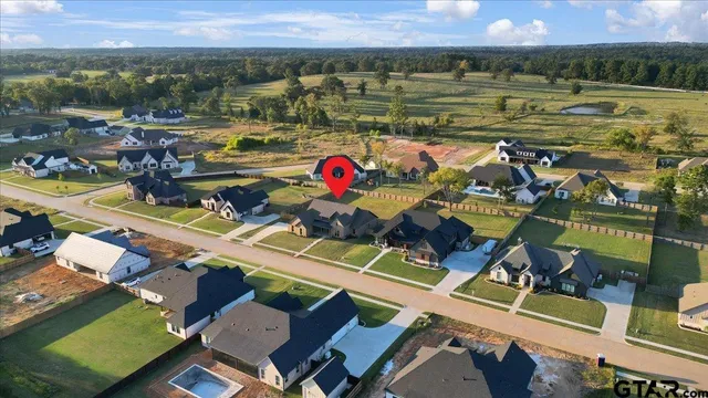 an aerial view of a houses with a swimming pool