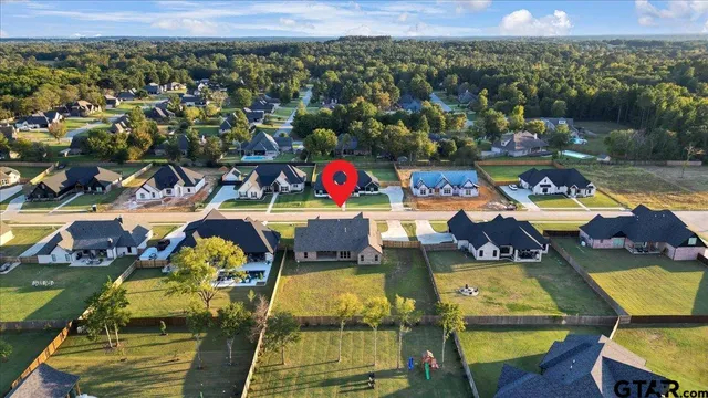 an aerial view of a house with a lake view