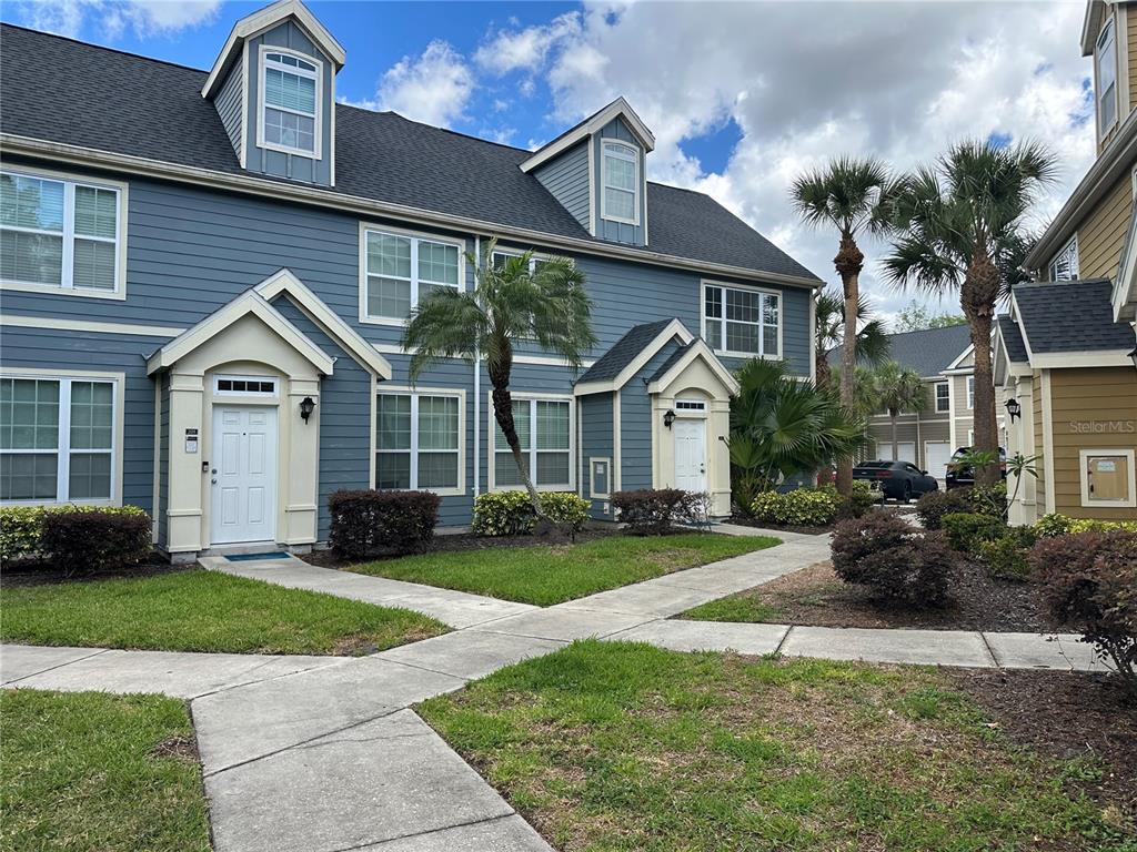 5601 Rosehill Road, Unit 201 Sarasota, FL 34233 - Photo 1 of 21 a front view of a house with a yard and garage