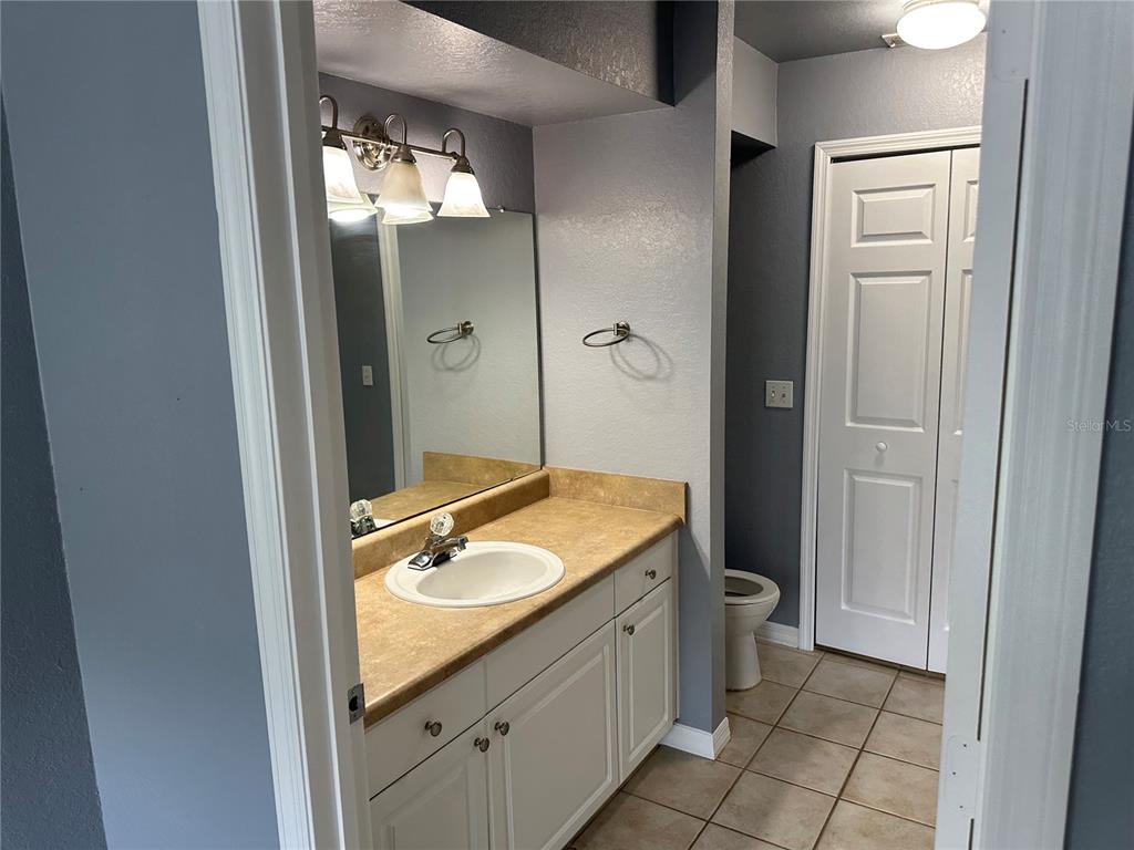 5601 Rosehill Road, Unit 201 Sarasota, FL 34233 - Photo 12 of 21 a bathroom with a granite countertop sink a mirror and a shower