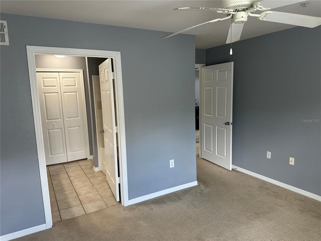 5601 Rosehill Road, Unit 201 Sarasota, FL 34233 - Photo 13 of 21 an empty room with closet and a ceiling fan