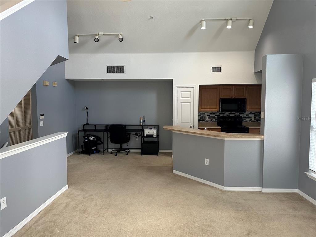5601 Rosehill Road, Unit 201 Sarasota, FL 34233 - Photo 18 of 21 a room with furniture and a flat screen tv