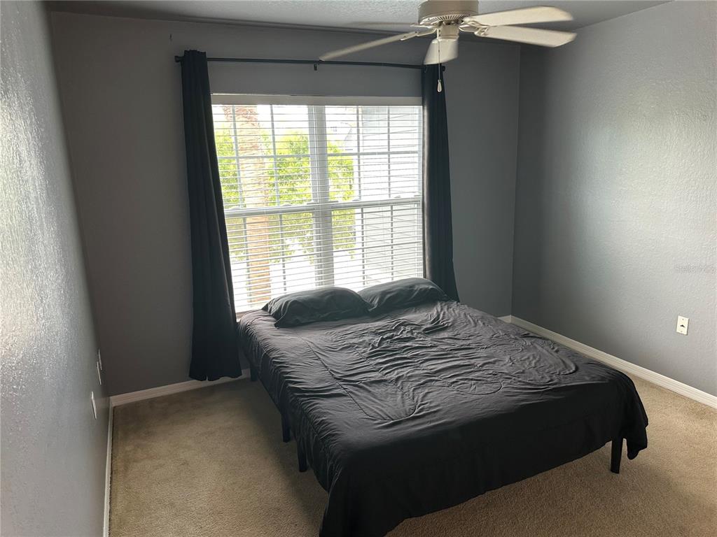 5601 Rosehill Road, Unit 201 Sarasota, FL 34233 - Photo 5 of 21 a bedroom with a bed and a window