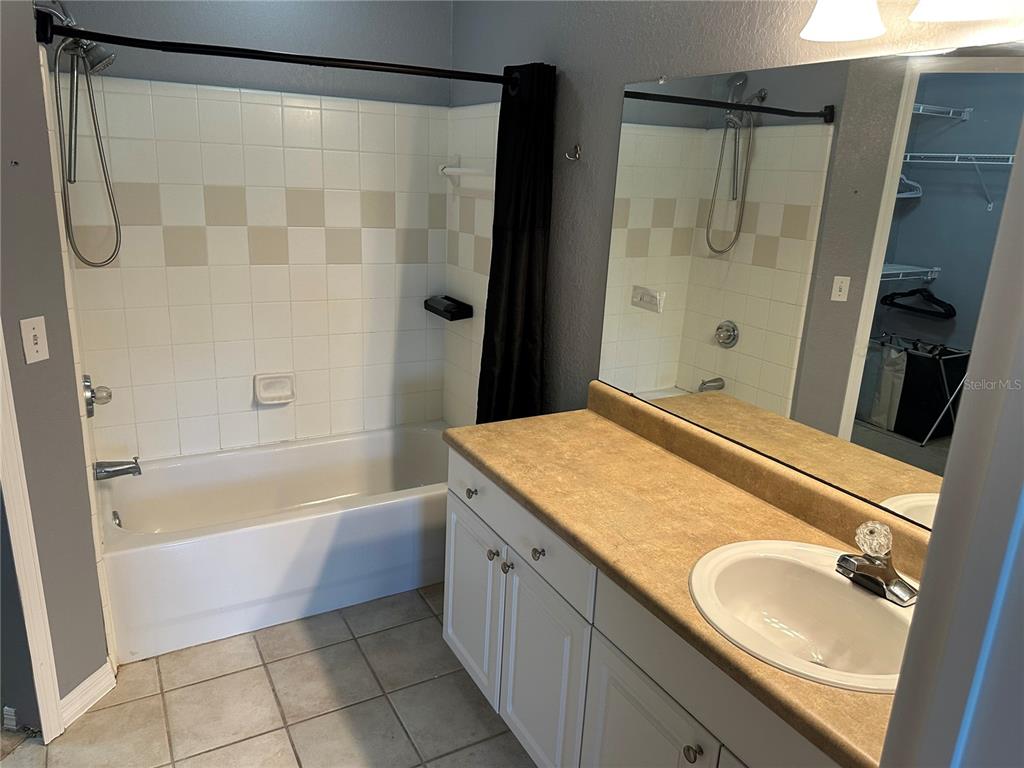 5601 Rosehill Road, Unit 201 Sarasota, FL 34233 - Photo 6 of 21 a bathroom with a granite countertop sink and a mirror