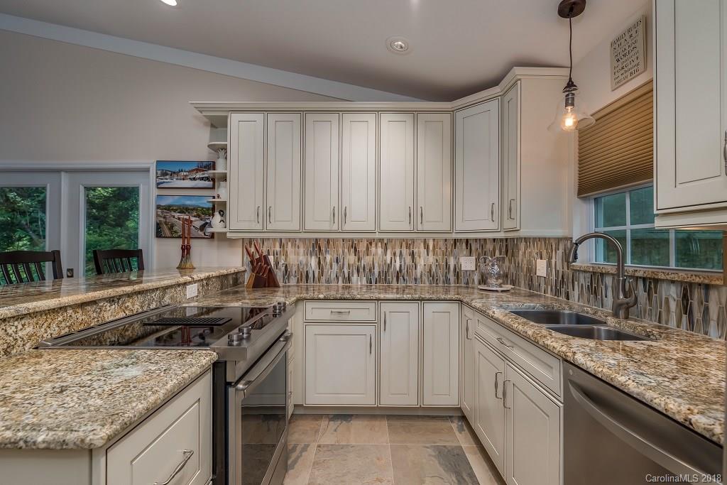 44 Jervey Road, Unit 3B Tryon, NC 28782 - Photo 12 of 29 a kitchen with granite countertop a sink stove and cabinets