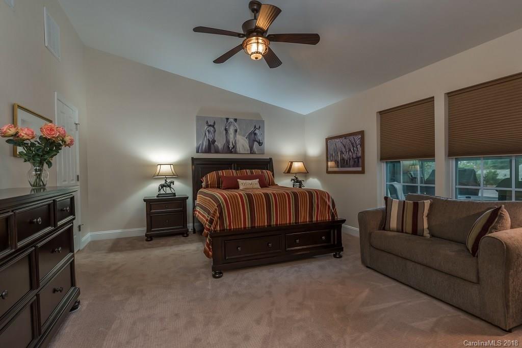 44 Jervey Road, Unit 3B Tryon, NC 28782 - Photo 14 of 29 a bedroom with furniture and a flat screen tv
