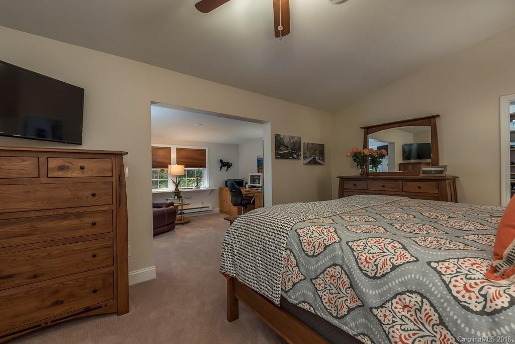 44 Jervey Road, Unit 3B Tryon, NC 28782 - Photo 17 of 29 a bedroom with a bed and a flat screen tv