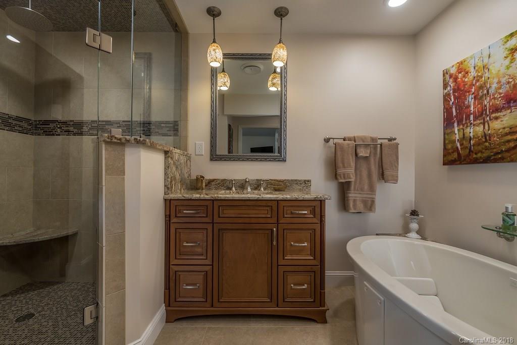44 Jervey Road, Unit 3B Tryon, NC 28782 - Photo 22 of 29 a spacious bathroom with a tub sink and mirror