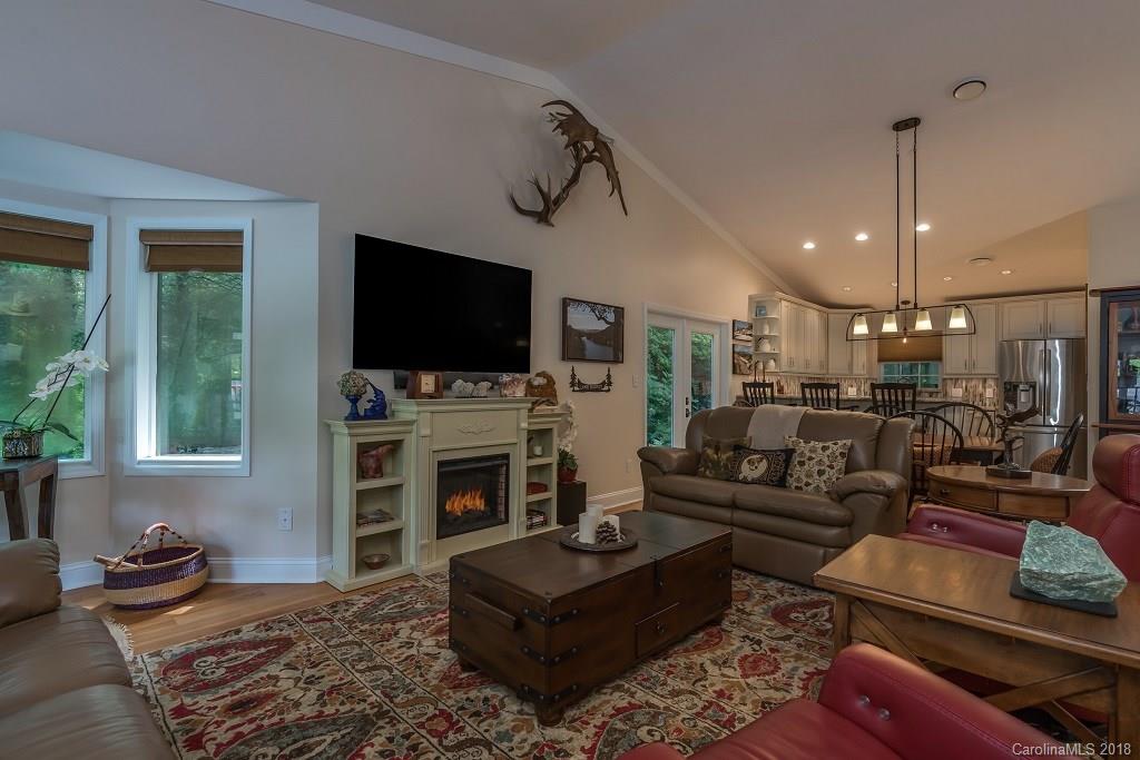 44 Jervey Road, Unit 3B Tryon, NC 28782 - Photo 4 of 29 a living room with fireplace furniture and a flat screen tv