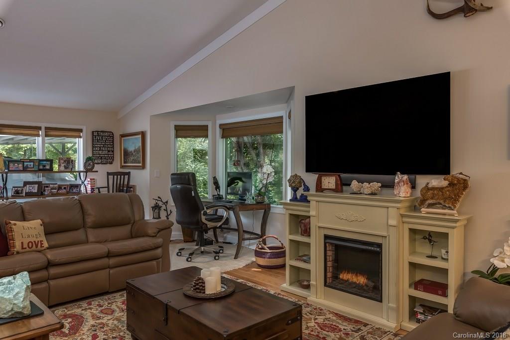 44 Jervey Road, Unit 3B Tryon, NC 28782 - Photo 7 of 29 a living room with furniture a flat screen tv and a fireplace