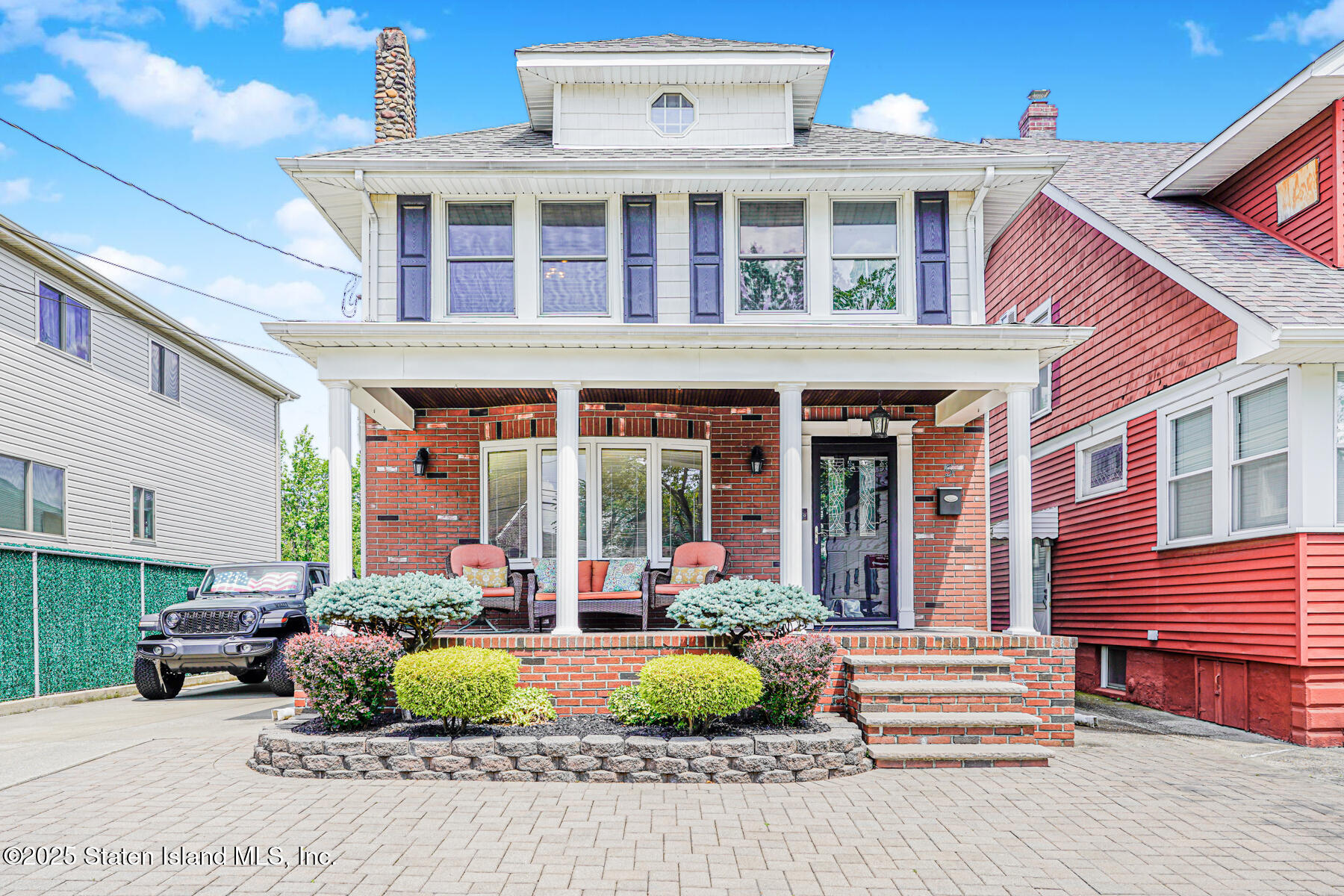 a front view of a house with garden and porch