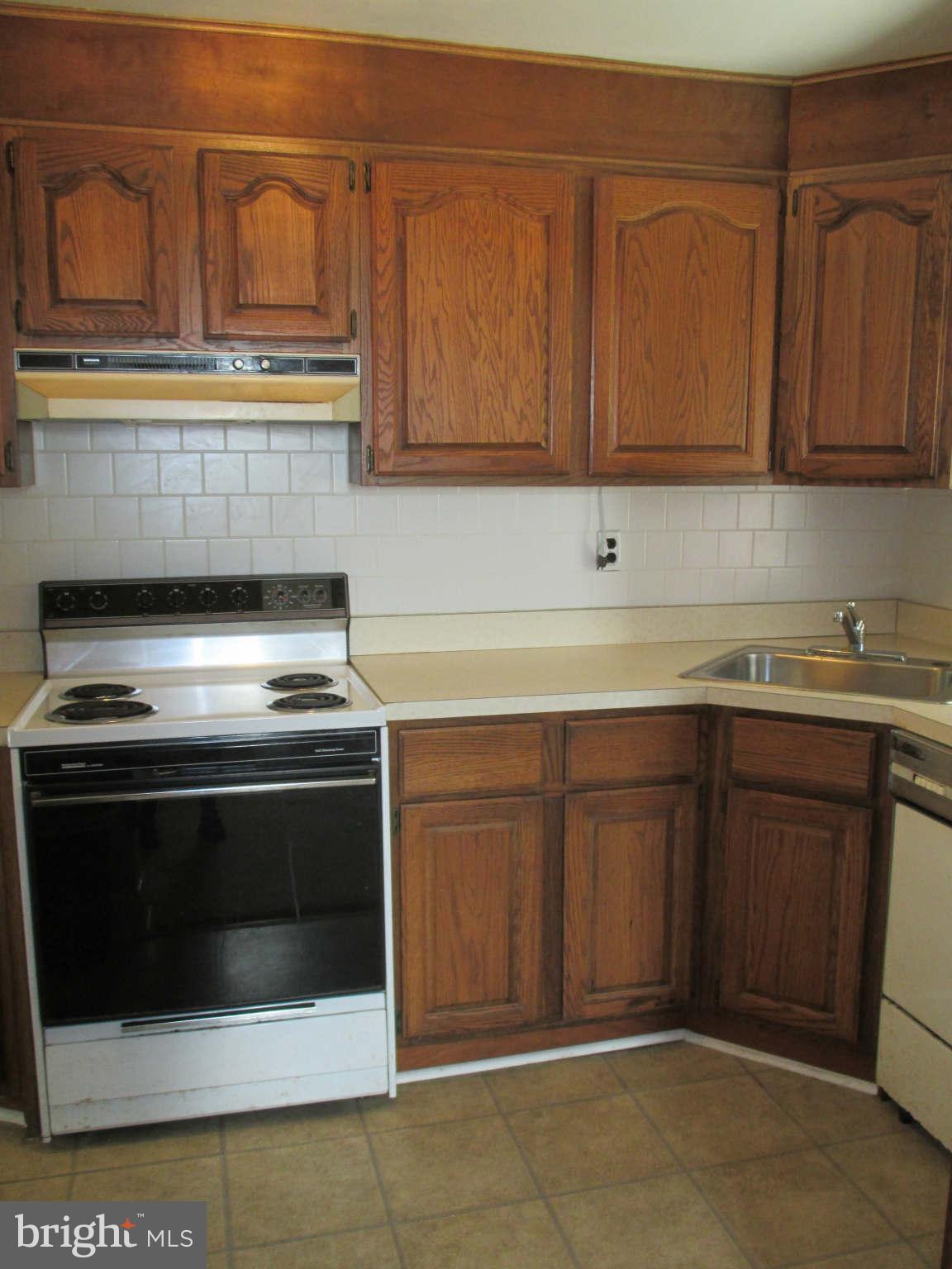 8126 Bon Air Road Baltimore, MD 21234 - Photo 11 of 28 a stove top oven sitting inside of a kitchen