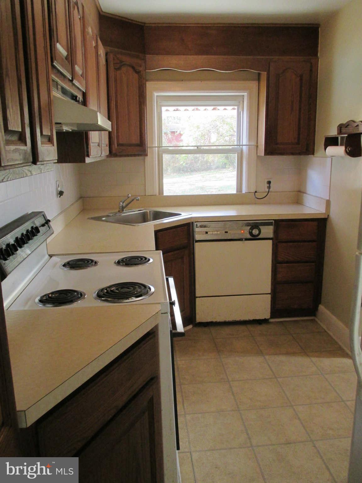 8126 Bon Air Road Baltimore, MD 21234 - Photo 12 of 28 a kitchen with a stove a sink and a refrigerator