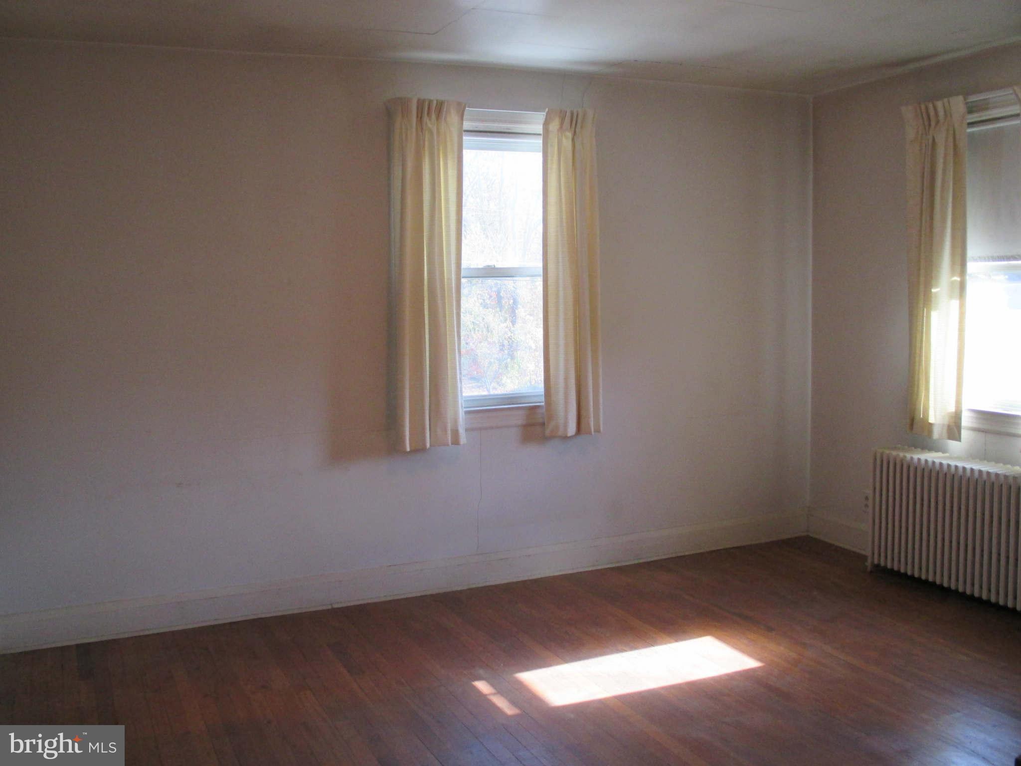 8126 Bon Air Road Baltimore, MD 21234 - Photo 15 of 28 an empty room with wooden floor and windows