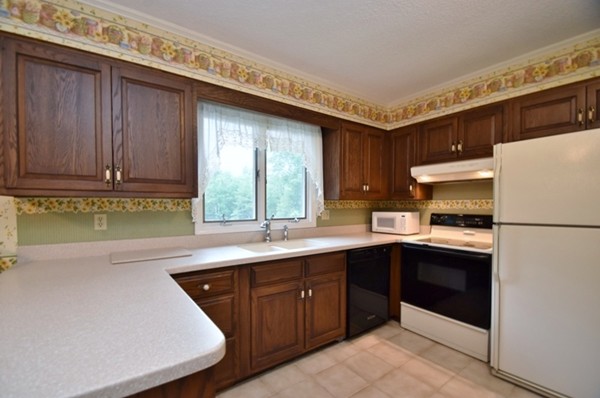 107 New Braintree Road Oakham, MA 01068 - Photo 2 of 22 a kitchen with a sink a stove and cabinets