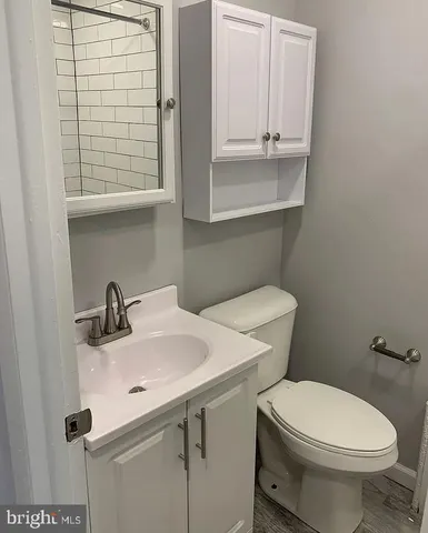 a bathroom with a sink a toilet and a window