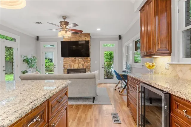a living room with furniture and a flat screen tv with kitchen view