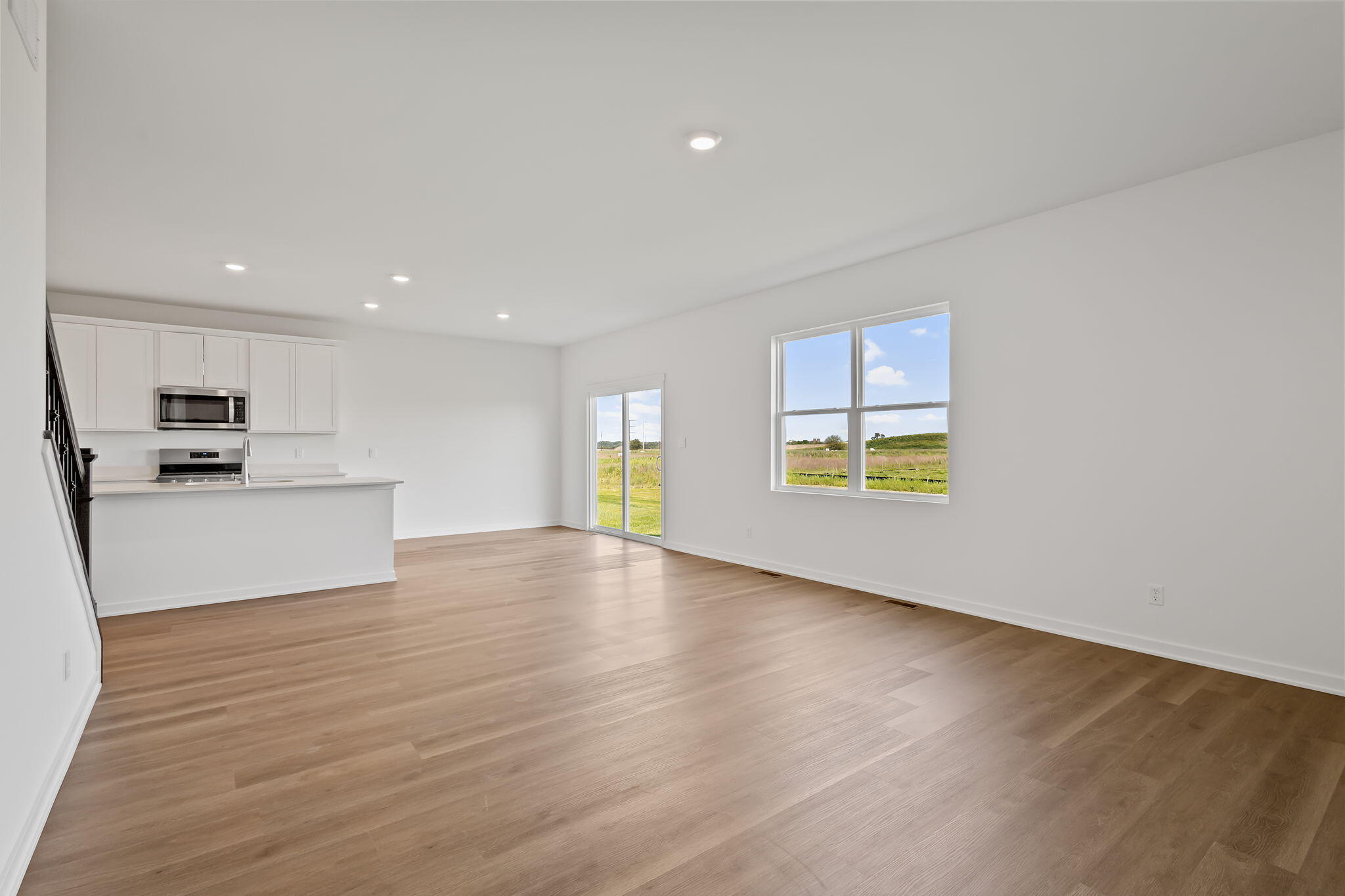10669 Blaine Street Crown Point, IN 46307 - Photo 6 of 27 a view of an empty room with a window and wooden floor