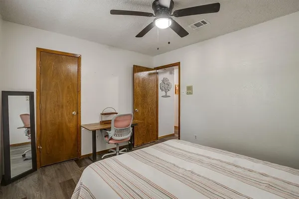 a bedroom with a bed and a desk