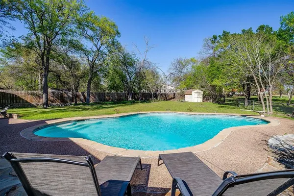 a view of a swimming pool with a patio